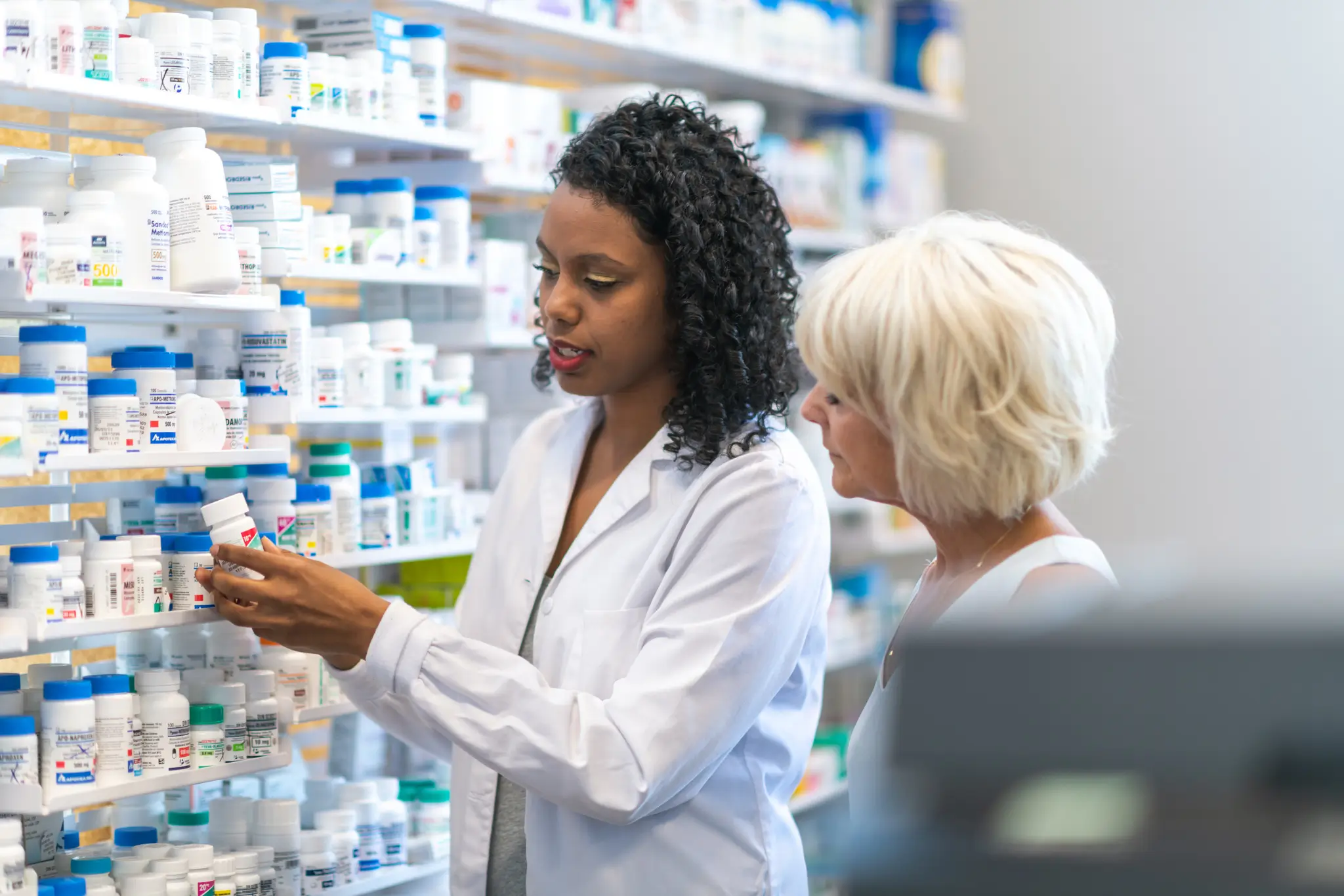 Pharmacist assisting patient