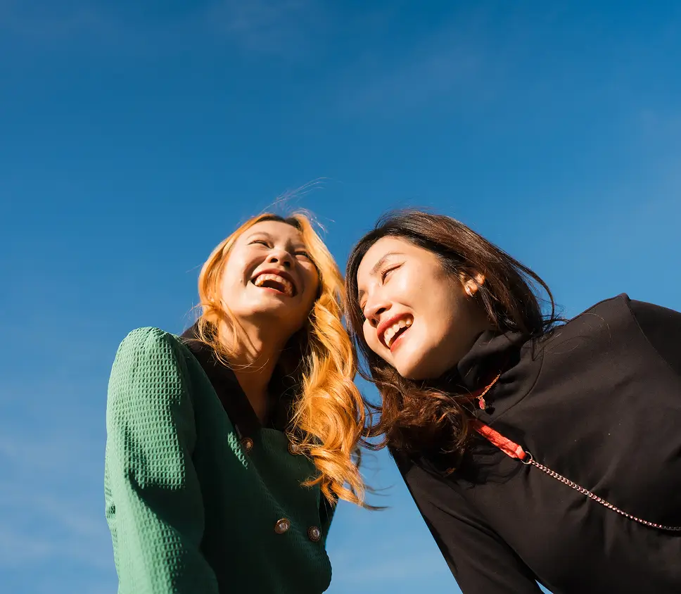 Two women smiling in sun