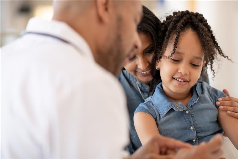 Mother and daughter sitting with a healthcare professional