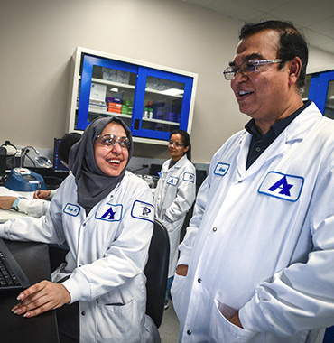 Apotex employees smiling in office setting