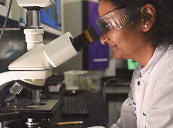 Woman looking into microscope