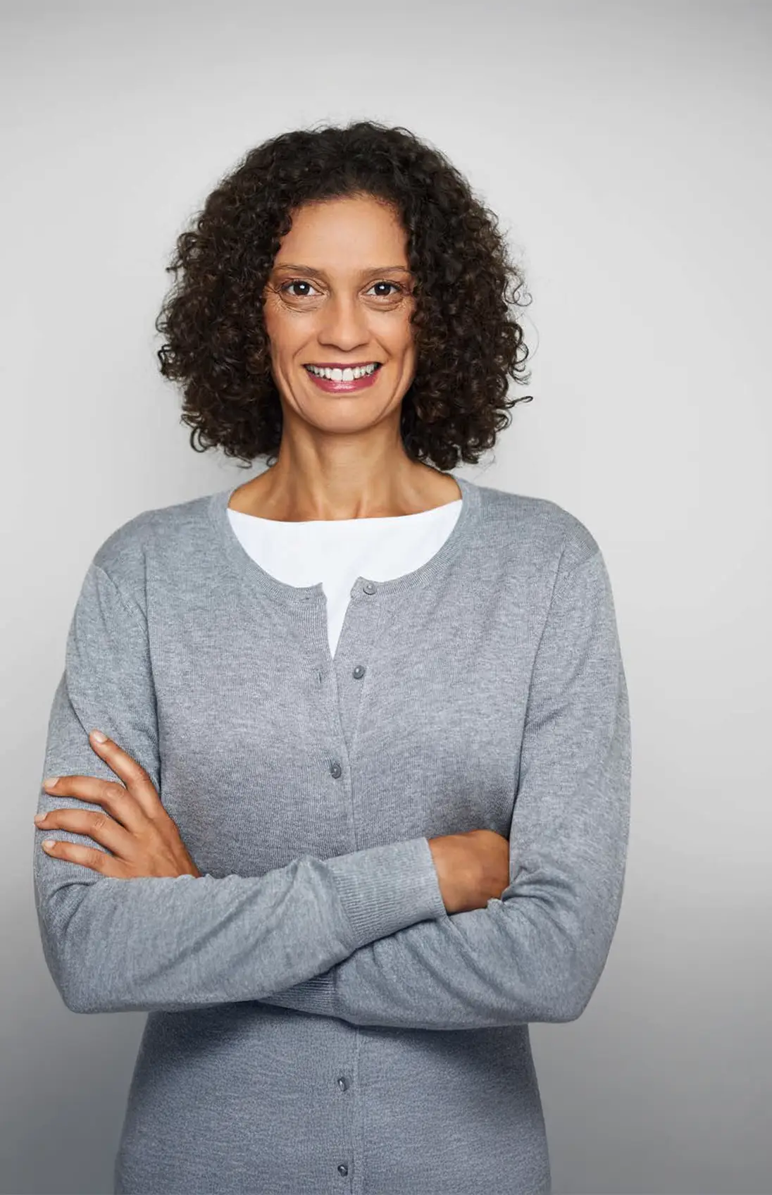 Woman with arms crossed and smiling