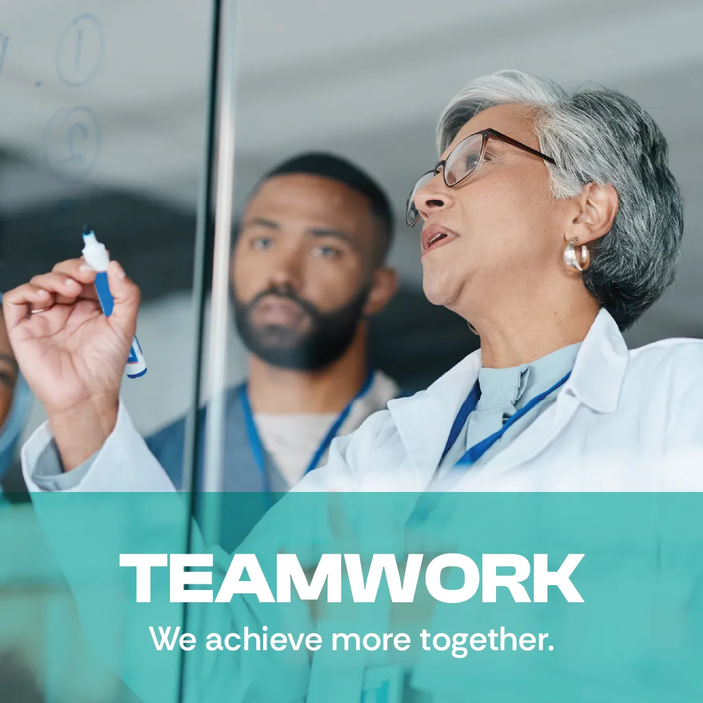 Teamwork. We achieve more together. A photo of a middle-aged female scientist and a young man writing on a writing on a white board. Teamwork. We achieve more together. A photo of a middle-aged female scientist and a young man writing on a writing on a white board.