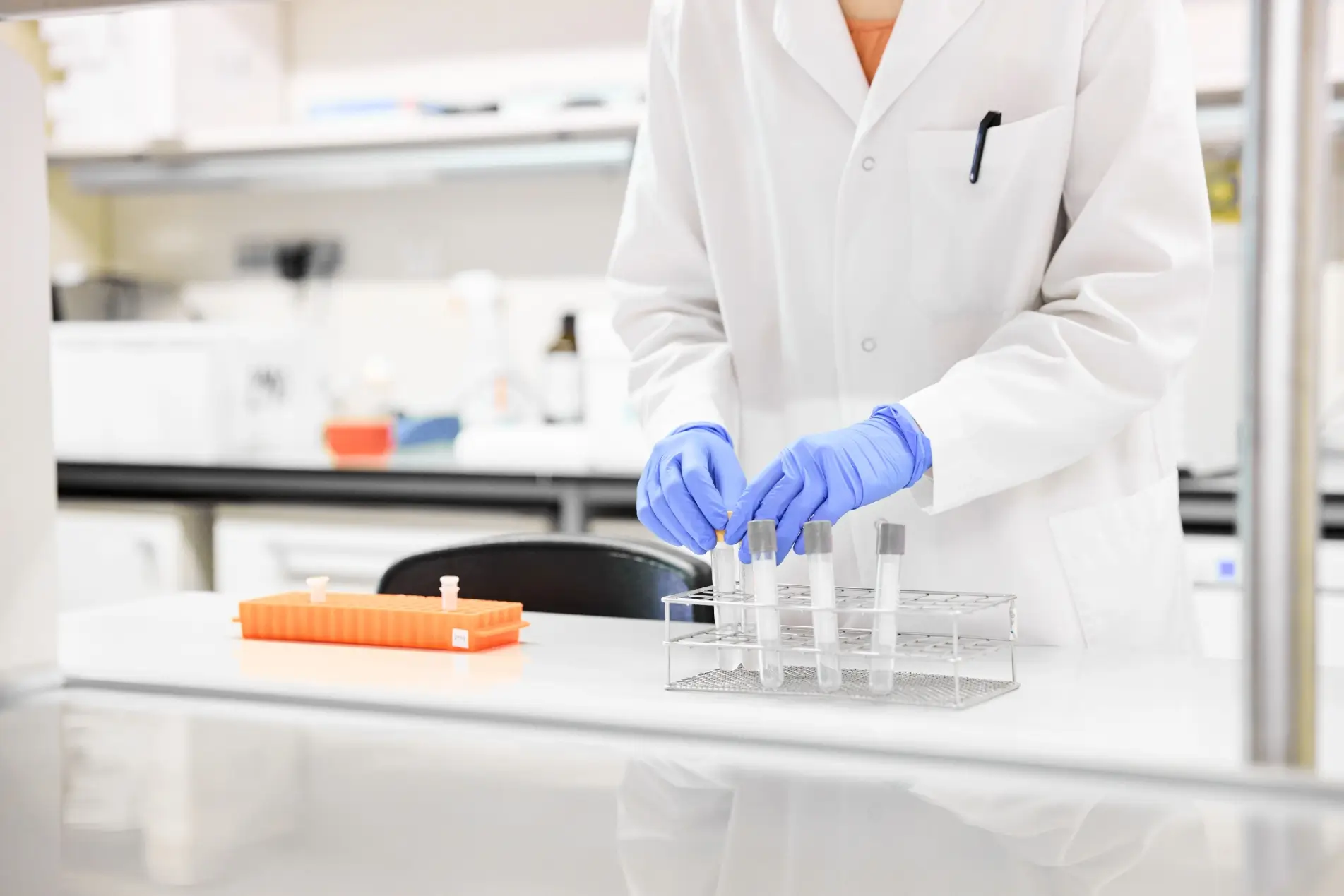scientist working in a lab with test tubes